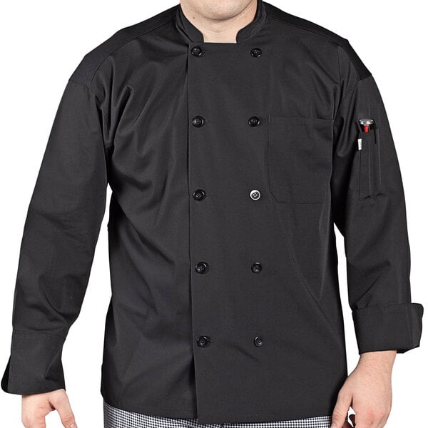 A man wearing a black Uncommon Chef long sleeve chef coat with mesh venting.