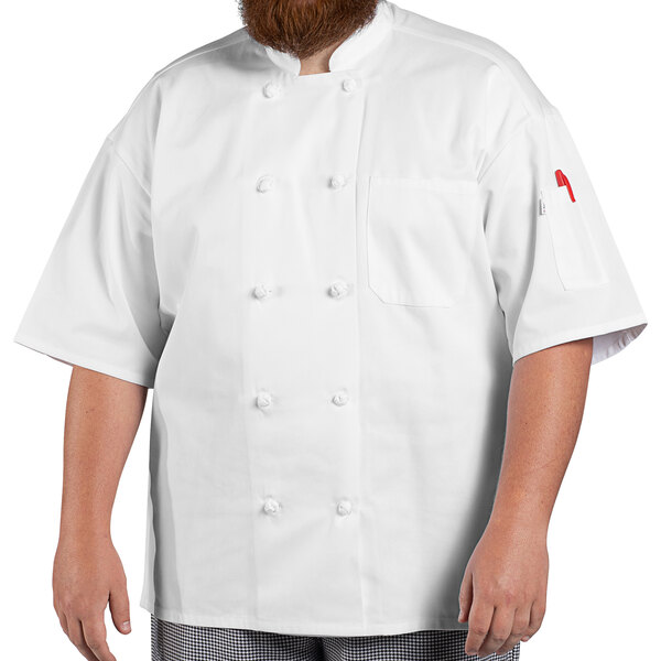 A man wearing a white Uncommon Chef Antigua Pro Vent short sleeve chef coat with mesh back.
