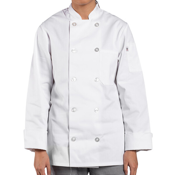 A woman wearing an Uncommon Chef white long sleeve chef coat.