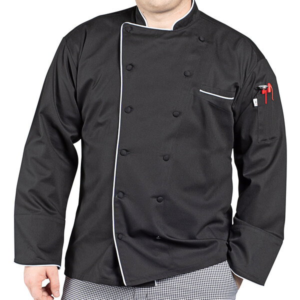 A man wearing a black Uncommon Chef coat with white piping.