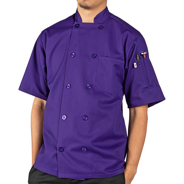 A man wearing a purple Uncommon Chef short sleeve chef coat.