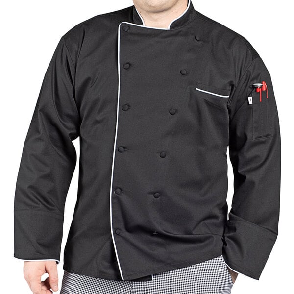 A man wearing a black Uncommon Chef long sleeve chef coat with white piping.