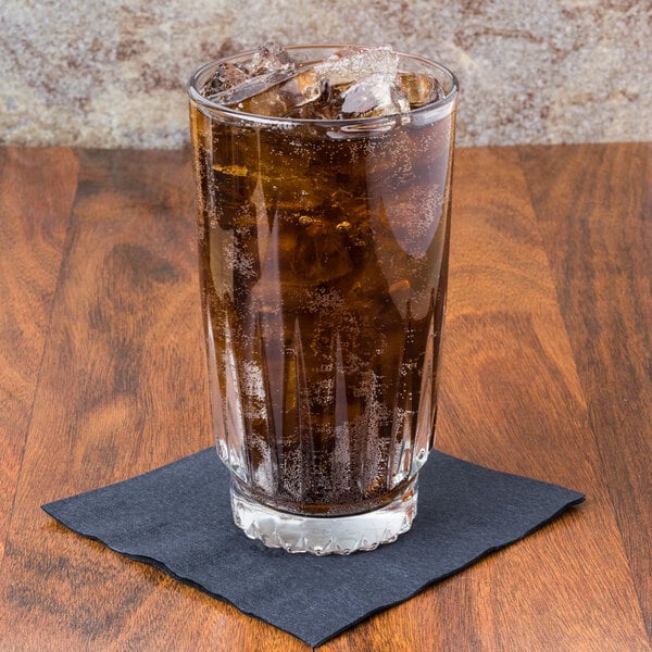 A Libbey Winchester cooler glass of cola on a napkin.