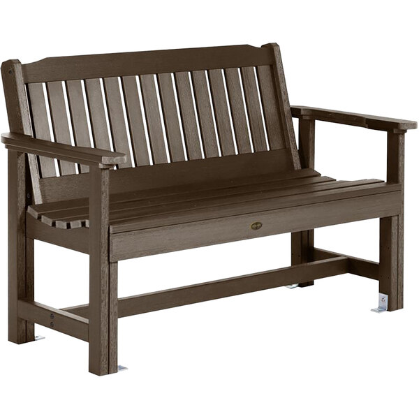 A brown wooden Sequoia garden bench with white armrests.