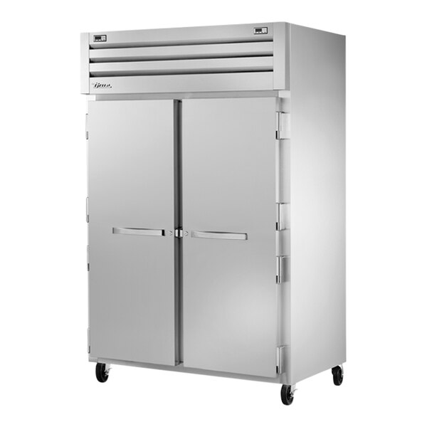 A True commercial combination refrigerator and freezer with two silver doors.