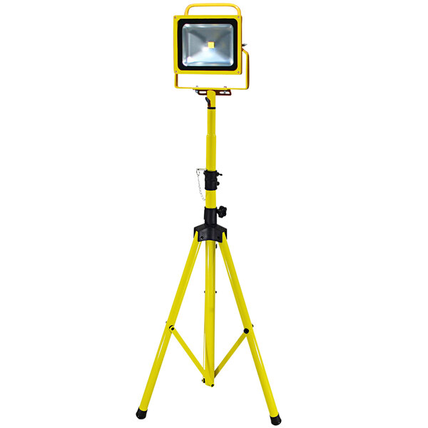 A yellow Lind Equipment tripod with a light on top.