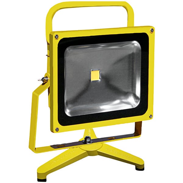A yellow and black Lind Equipment battery-powered LED floodlight on a floor stand.