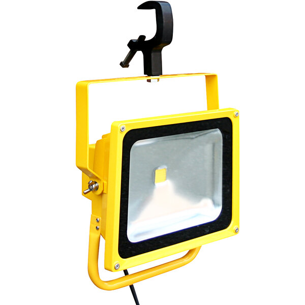 A yellow and black Lind Equipment LED floodlight with a clamp.