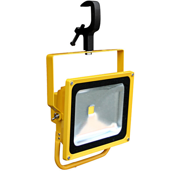 A yellow and black Lind Equipment rechargeable LED floodlight with a clamp.