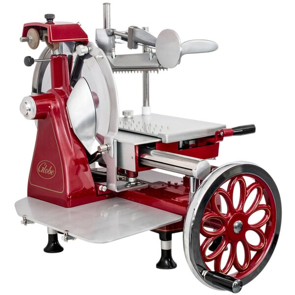 A red and silver Globe manual meat slicer with a flywheel.