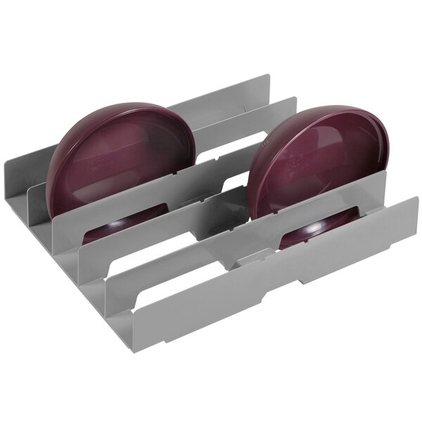A plastic dish rack with three plates on it.