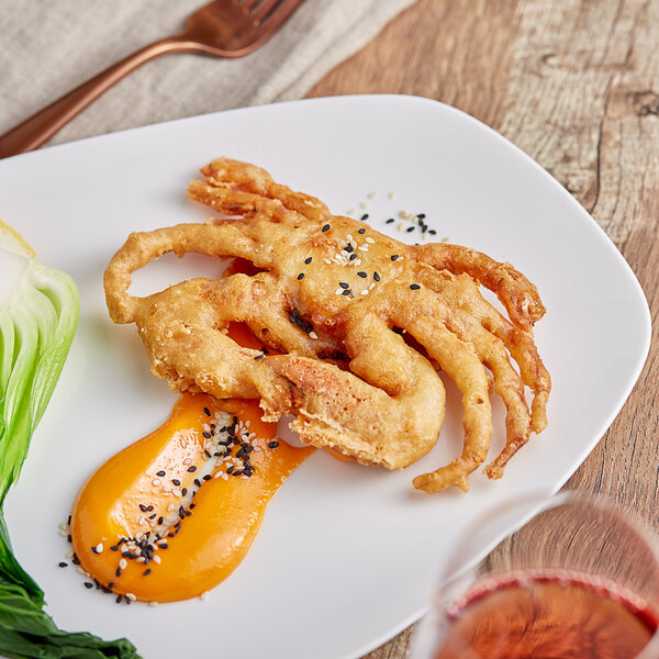 A plate of Handy Jumbo Tempura Breaded Soft Shell Crabs with vegetables on a table.