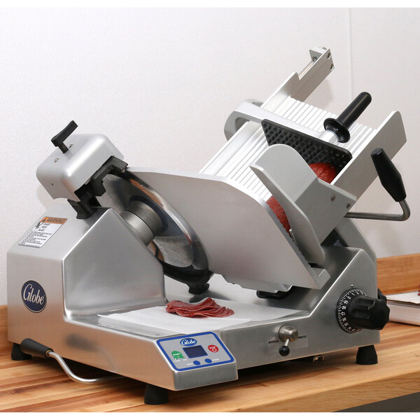 A Globe heavy-duty automatic meat slicer on a counter.