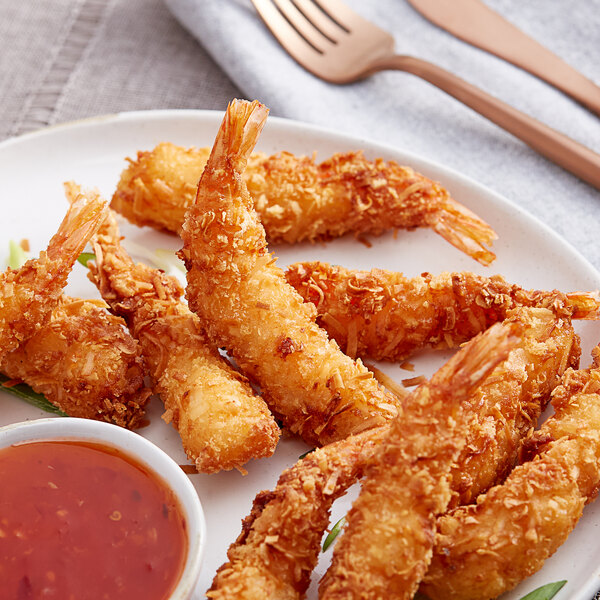 A plate of Handy Coconut Breaded Shrimp with dipping sauce.
