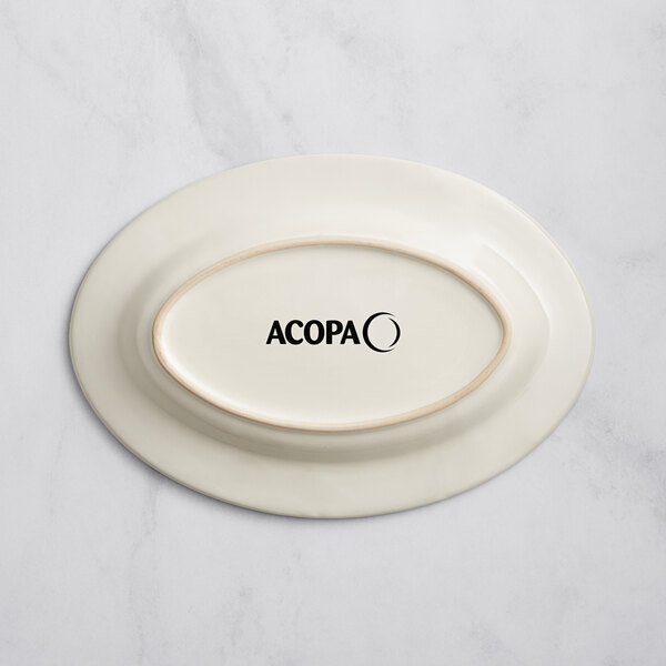 An ivory stoneware oval platter with embossed oval and wide rim.