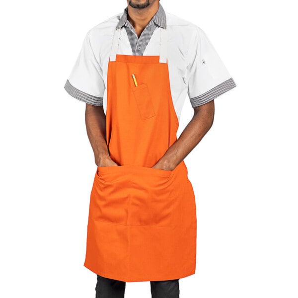 An orange Uncommon Chef apron with 3 pockets.