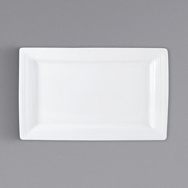 A white rectangular Tuxton Pacifica china plate with an embossed border.