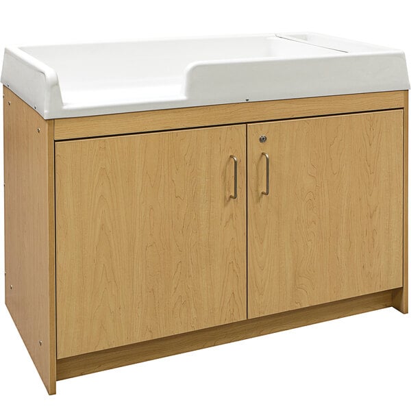 A Tot Mate maple laminate infant changing table with two drawers.