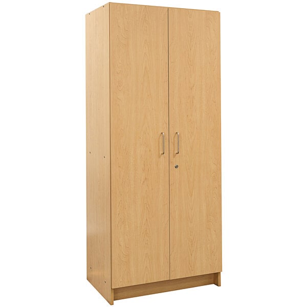 A Tot Mate maple wooden tall cabinet with two doors.