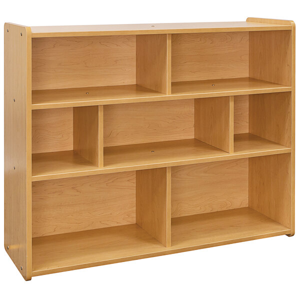 A wooden Tot Mate school age compartment storage unit with shelves.