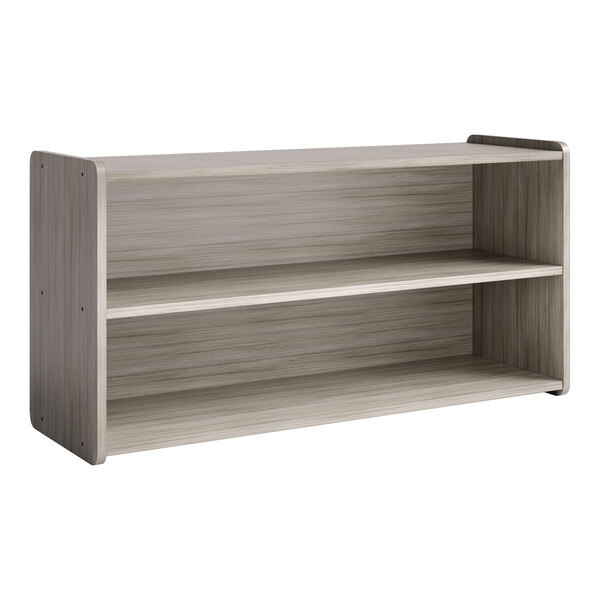 A Tot Mate Shadow Elm laminate toddler double sided storage shelf with two shelves.