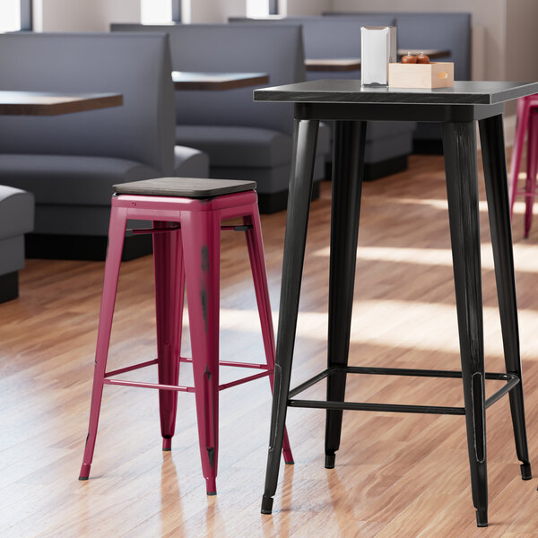 Lancaster Table & Seating Alloy Series Distressed Sangria Stackable Metal Indoor Industrial Barstool with Black Wood Seat