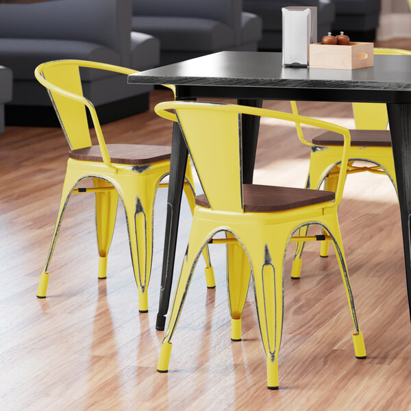 Lancaster Table & Seating Alloy Series Distressed Yellow Metal Indoor Industrial Cafe Arm Chair with Vertical Slat Back and Walnut Wood Seat