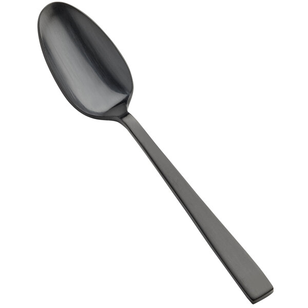 A close-up of a Bon Chef stainless steel spoon with a black matte handle.