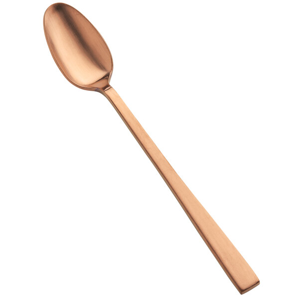 A close-up of a Bon Chef matte rose gold iced tea spoon with a long handle.
