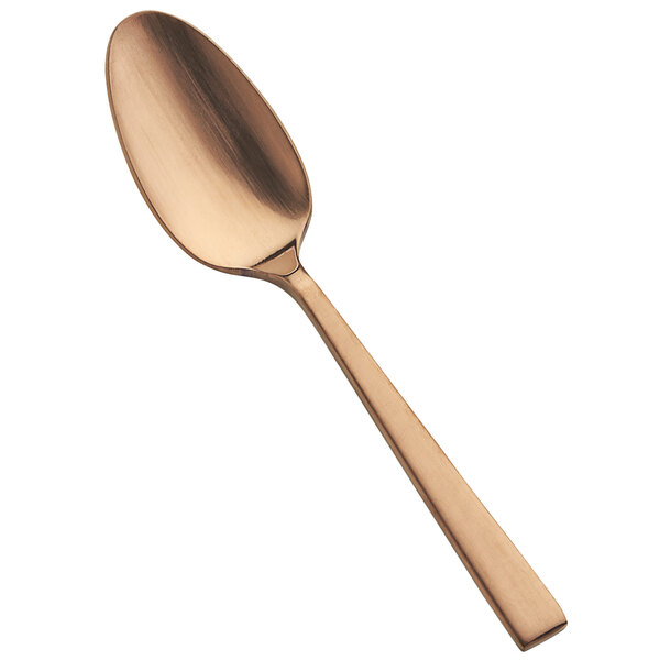 A close-up of a Bon Chef stainless steel demitasse spoon with a matte rose gold finish.