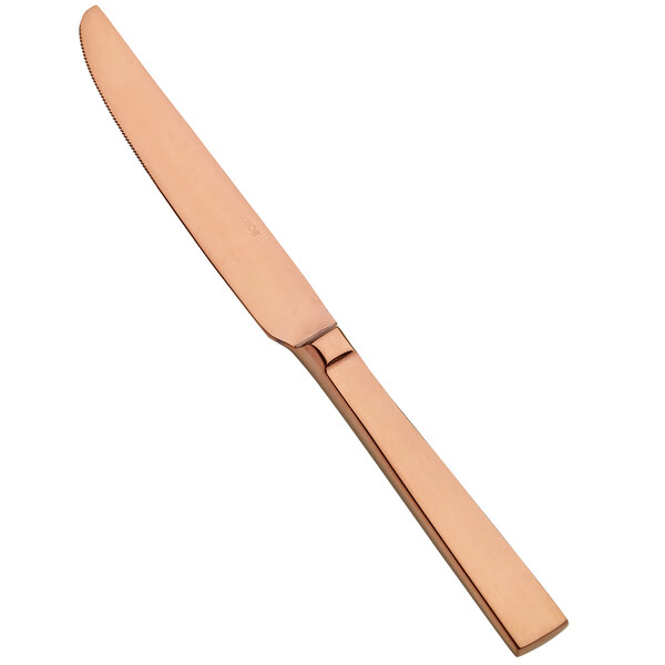 A close up of a Bon Chef rose gold fruit/dessert knife with stainless steel blade.
