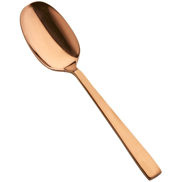 A close-up of a Bon Chef stainless steel spoon with a rose gold handle.
