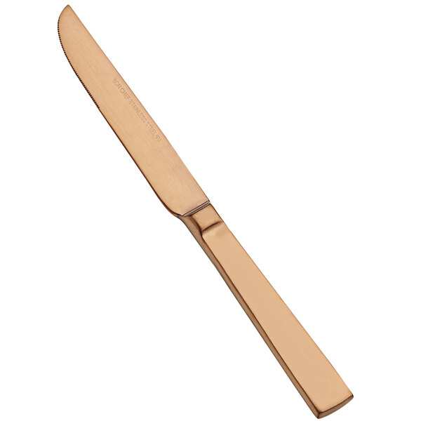 A Bon Chef stainless steel dinner knife with a matte rose gold handle.