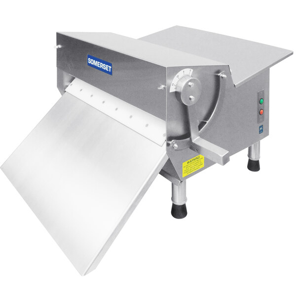 A Somerset countertop dough sheeter with a metal cover.
