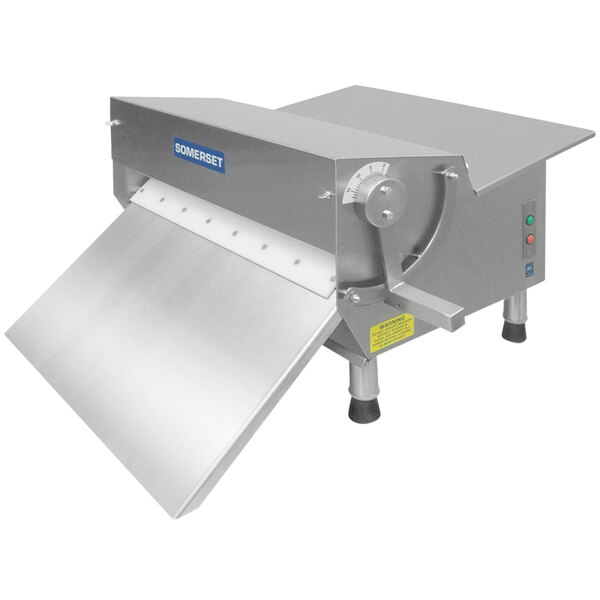 A Somerset dough sheeter with a metal cover.