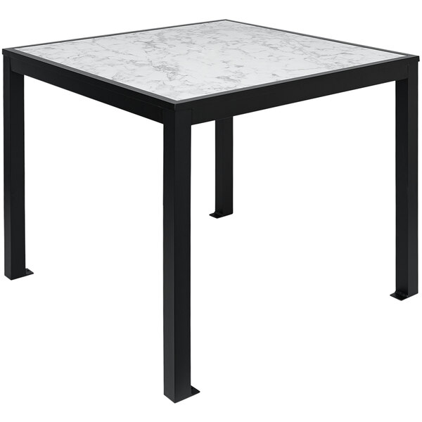 A BFM Seating black aluminum table with a Carrara marble top.