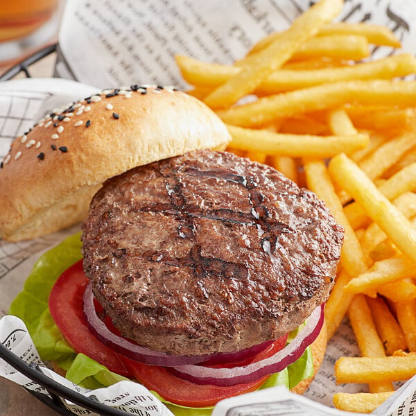 A Warrington Farm Meats burger on a bun with fries in a basket.