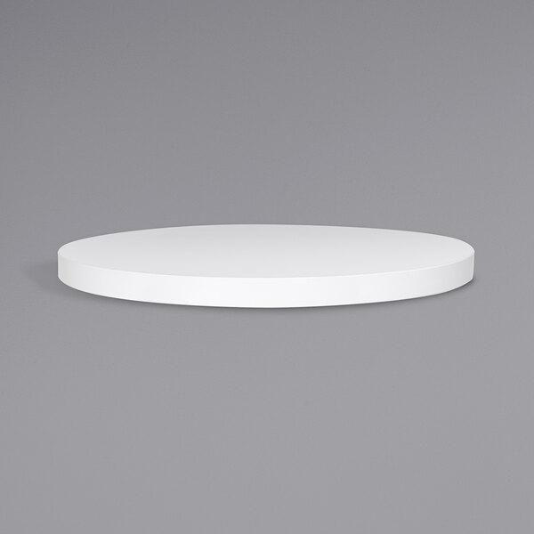 A BFM Seating white round table top on a gray background.