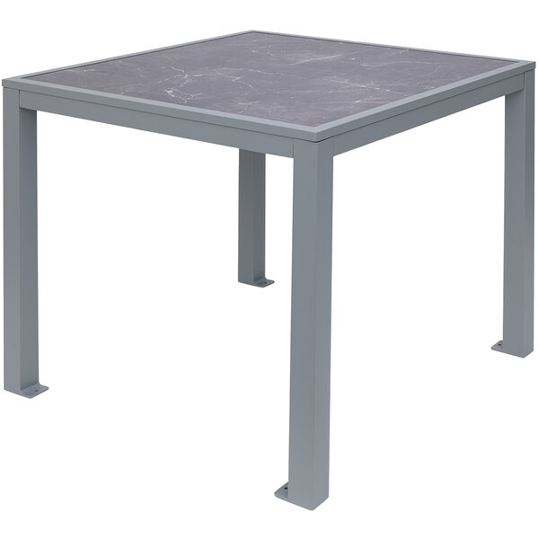 A grey table with a metal base and a marble top.
