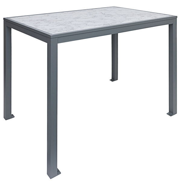 A BFM Seating bar height table with a Carrara marble top and aluminum base.