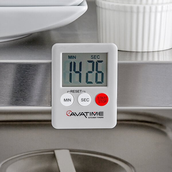 A white AvaTime Mini Digital kitchen timer on a stainless steel surface.
