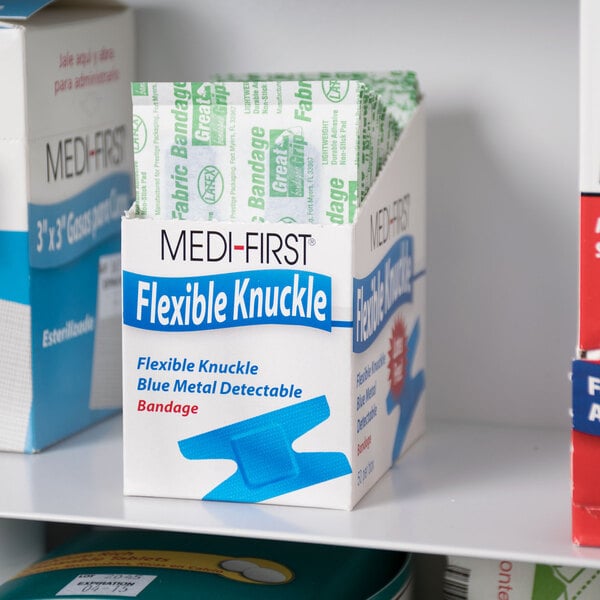 A blue and white box of MedFirst Blue Woven Adhesive Knuckle Bandages.