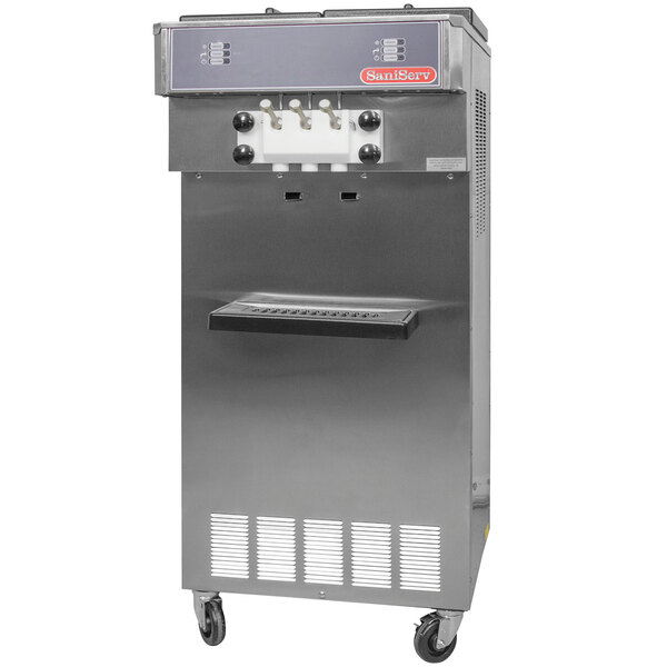 A SaniServ water cooled soft serve ice cream machine with a stainless steel cabinet and two hoppers.