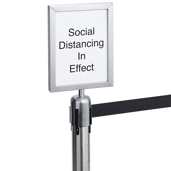 An American Metalcraft sign that says "Social Distancing In Effect" with a black ribbon on it.