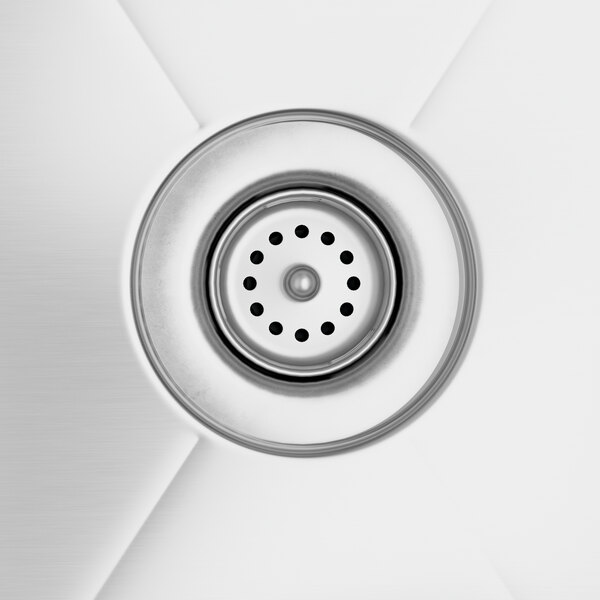 A close-up of the sink drain on a Regency stainless steel corner work table with sink.