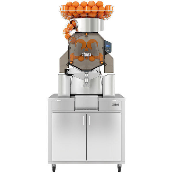 A Zumex Speed S+ commercial juicer with oranges on top.