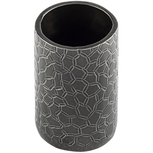A black round aluminum cylinder with a crackle pattern holding sugar tubes.