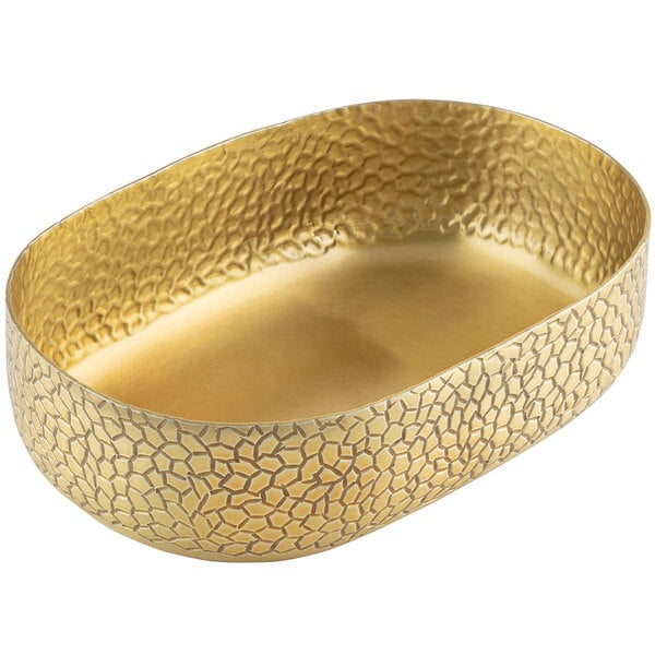 A Tablecraft gold oval aluminum bowl with a patterned design.