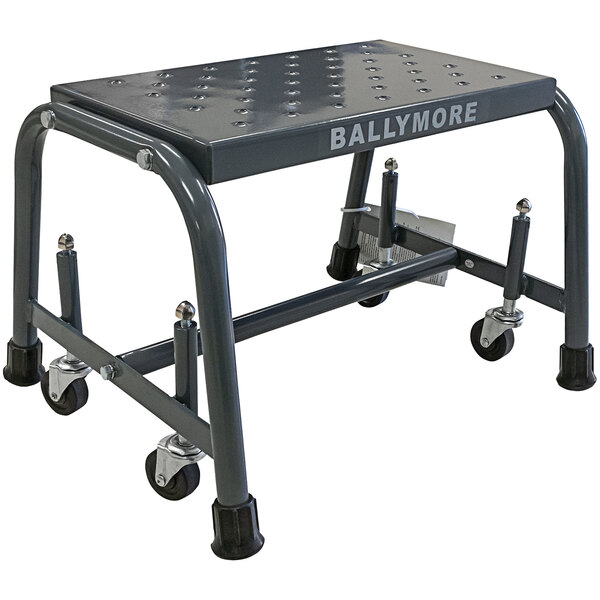 A grey metal Ballymore rolling ladder with black wheels.