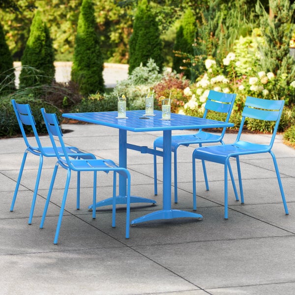 A blue Lancaster Table & Seating outdoor dining set on a patio with drinks on the table.